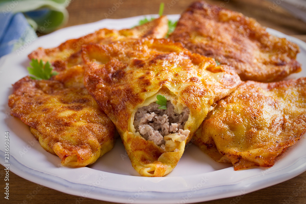 Savor crepes with meat filling. Crepes stuffed with beef sausage. horizontal Savor crepes with meat filling. Crepes stuffed with beef sausage. horizontal