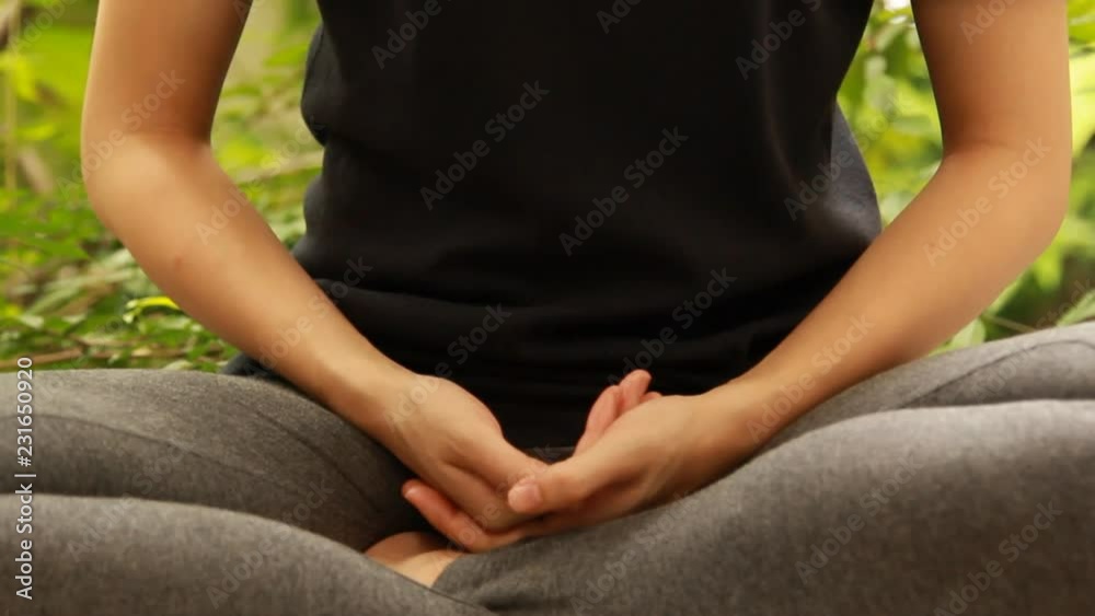 Asian young woman meditating in the garden Asian young woman meditating in the garden