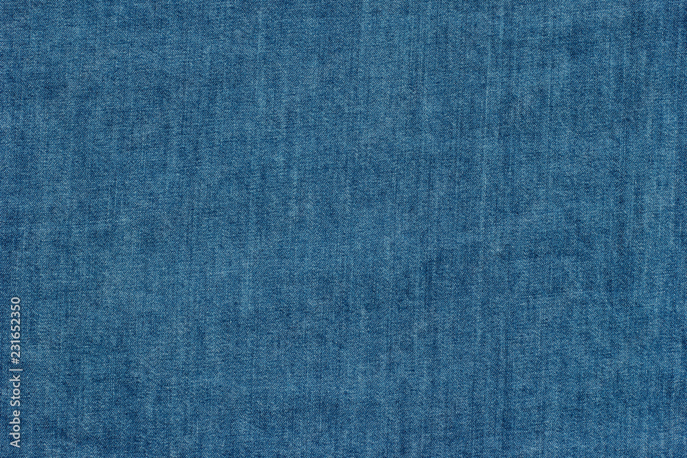 Old blue denim jeans texture or background with visible fibers Old blue denim jeans texture or background with visible fibers