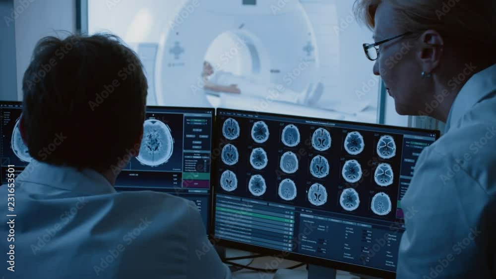 In Control Room Doctor and Radiologist Discuss Diagnosis while Watching(00)