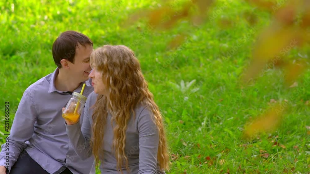 man and woman in the Park, drinking juice, playing, laughing man and woman in the Park, drinking juice, playing, laughing