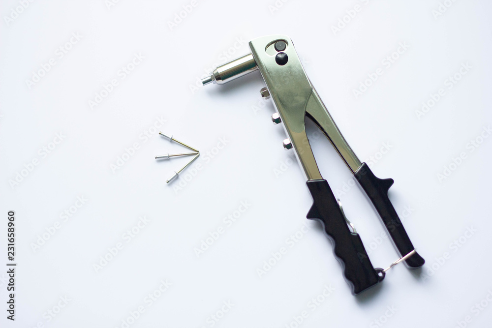 Detail of an old rivet gun (hand riveter) with rivets on a white background  Stock Photo | Adobe Stock