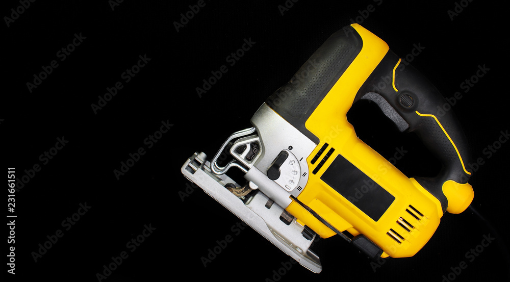 Isolated electric jig saw on a black background Isolated electric jig saw on a black background