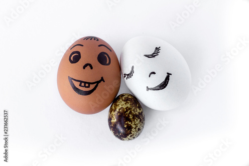 Funny eggs imitating a happy mixed family with multicolored baby