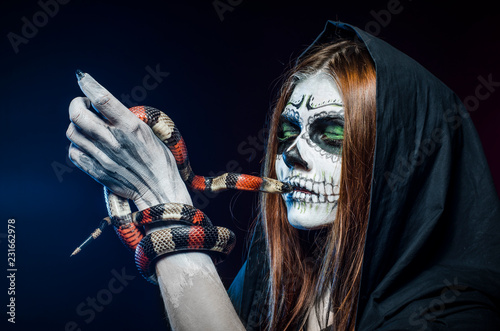 Beautiful halloween portrait and king snake. Dead face.