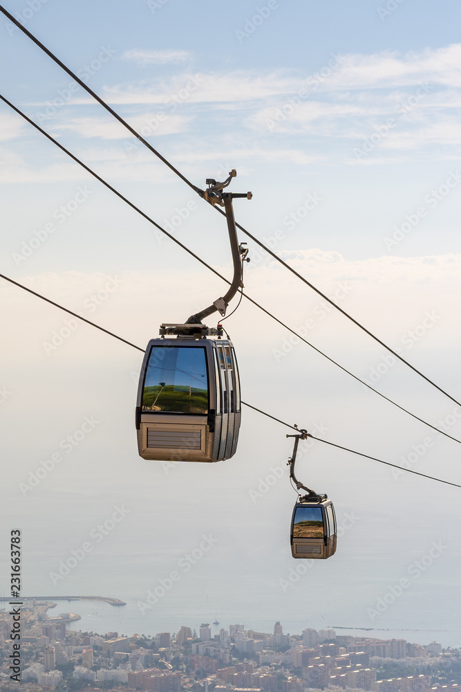 cable car in the mountains against the background of the city