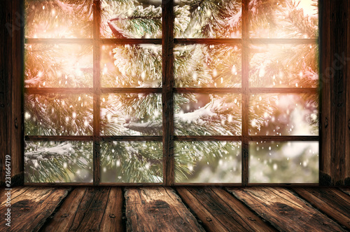 Blurred background of winter window landscape and shabby table place. Winter homely and cozy atmosphere. Christmas homely concept.  