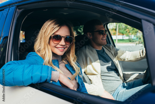 smiling couple of tourists driving car while traveling together © LIGHTFIELD STUDIOS