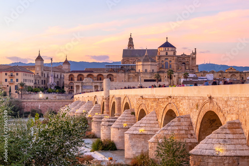 Long exposure photography of Mosque-Cathedral and the Roman Bridge at sunset in Cordoba, Andalusia, Spain