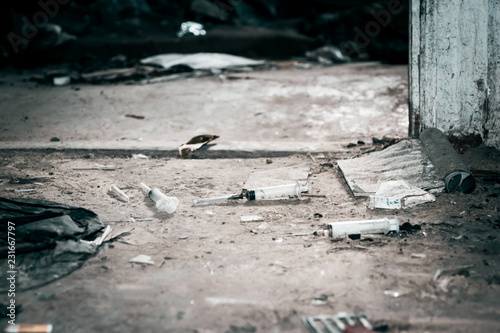 Fotografie Old abandoned house and used plastic syringes