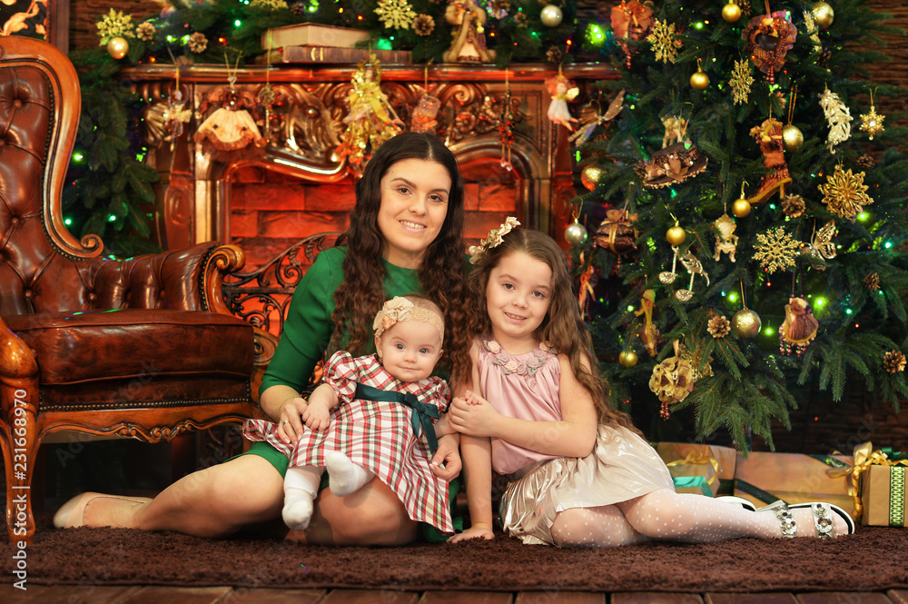Portrait of happy mother with cute little daughters Portrait of happy mother with cute little daughters