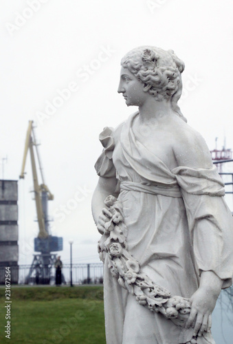 statue in industrial landscape