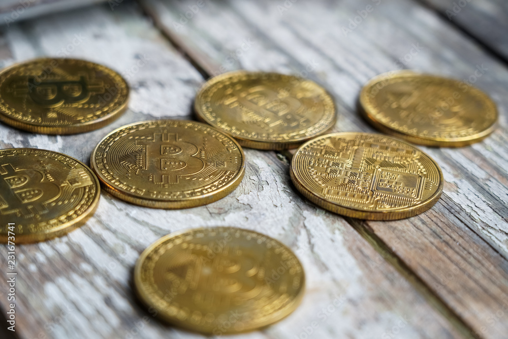 Gold Bitcoin money on wooden table. Electronic crypto currency Gold Bitcoin money on wooden table. Electronic crypto currency