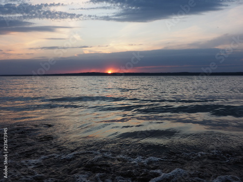 Sunset. On the big river. Coast. Beautiful clouds. Waves. Summer. Russia  Ural  Perm region