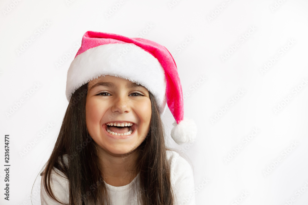Christmas time - happy child girl with Santa Claus Hat Christmas time - happy child girl with Santa Claus Hat