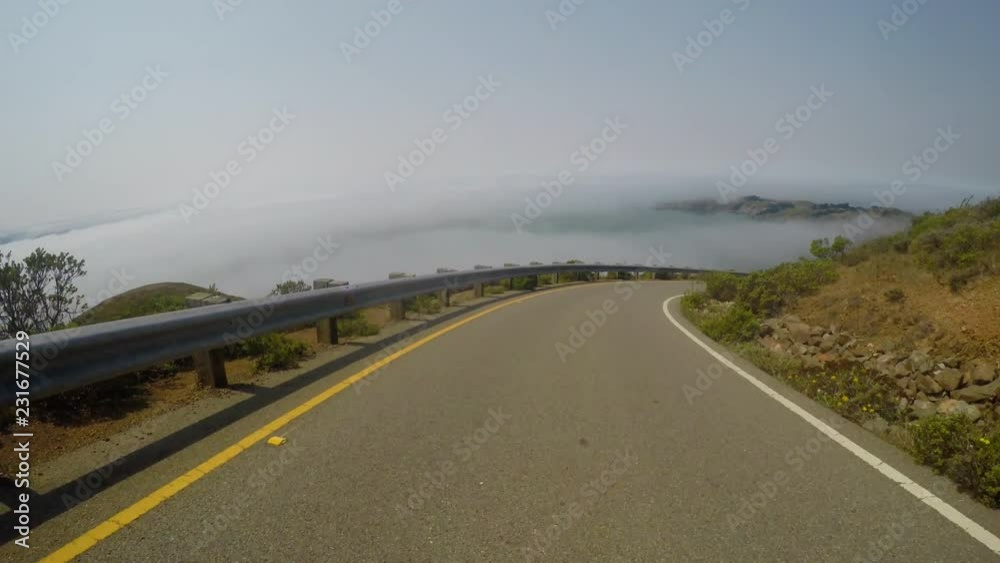 Driving POV: Descending a steep winding road in the Marin Headlands Driving POV: Descending a steep winding road in the Marin Headlands
