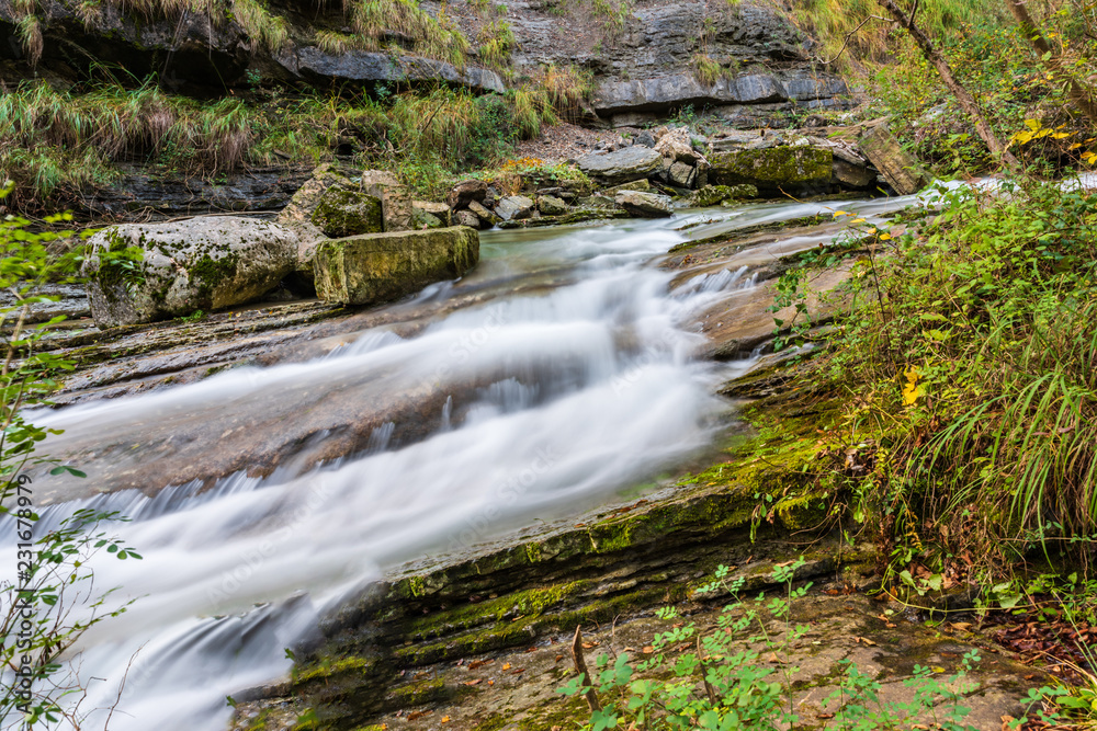 Waterfall and autumn colors. Magic of the Julian pre-Alps.