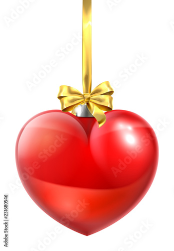 A heart shaped Christmas ball bauble ornament with a gold bow and ribbon