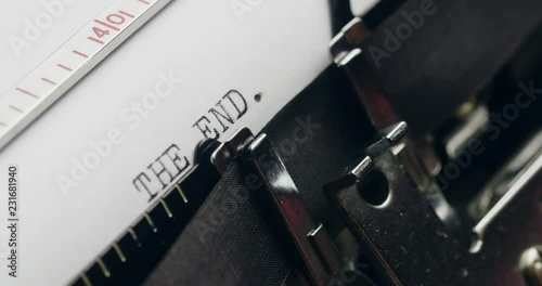 Writer types THE END on a typewriter. Extreme closeup shot.