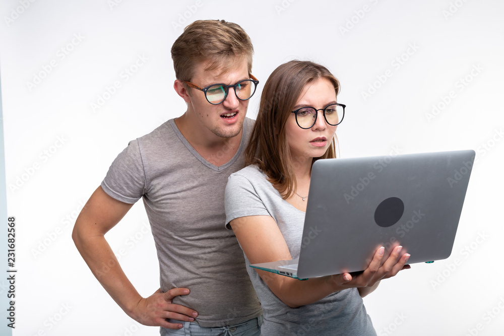 People and education concept - Two young student looking in laptop over white background
