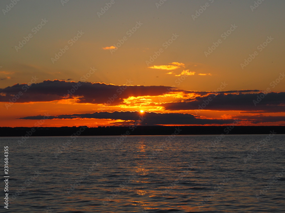 Sunset. On the big river. Coast. Beautiful clouds. Summer. Russia, Ural, Perm region