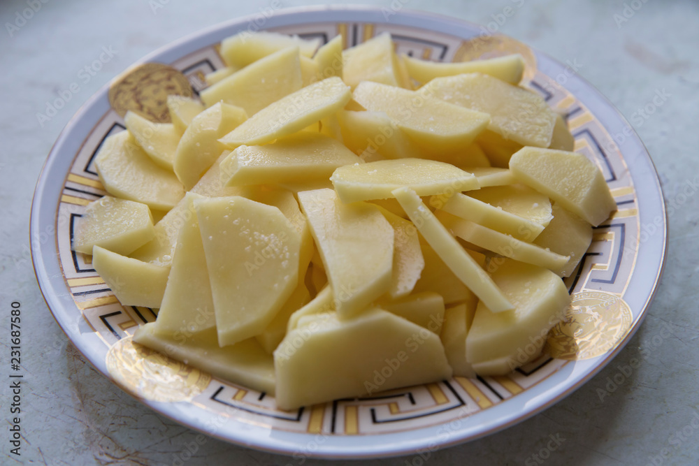 Chopped potatoes. In the chopped potato plate . Sliced, peeled raw potatoes on a board . Chopped potatoes in a bowl . Diced potatoes - as an ingredient to a potato based dish Chopped potatoes. In the chopped potato plate . Sliced, peeled raw potatoes on a board . Chopped potatoes in a bowl . Diced potatoes - as an ingredient to a potato based dish