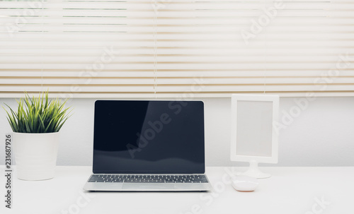 Laptop computer blank screen on white desk © sorapop
