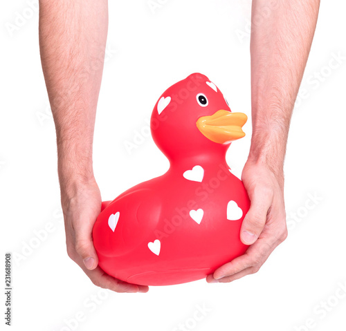 Hands holding large red rubber duck photo