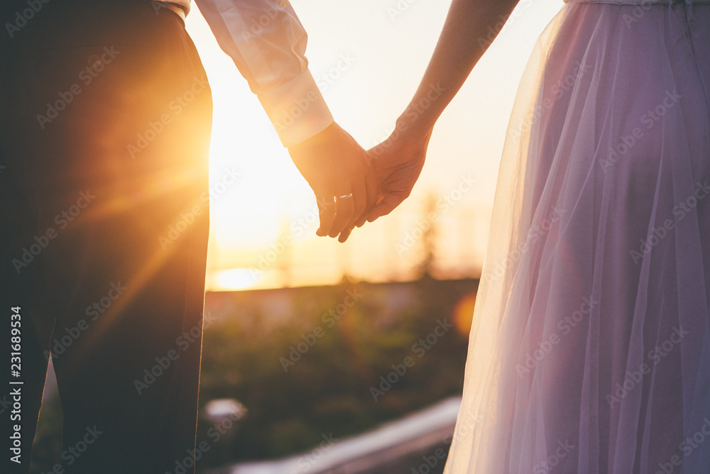 Bride and groom holding hands closeup - obrazy, fototapety, plakaty 