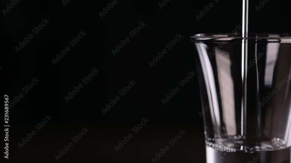 Bartender making alcohol coctail in restaurant. Expert barman is adding ingredient cocktail at night club. Close up. Bartender making alcohol coctail in restaurant. Expert barman is adding ingredient cocktail at night club. Close up.