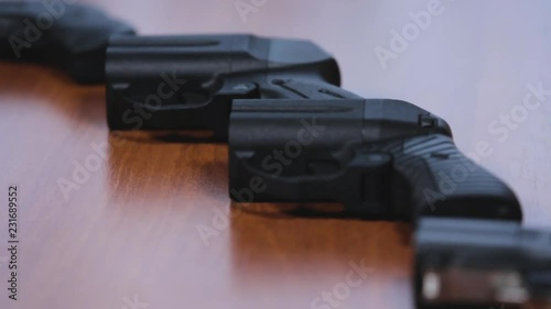 Traumatic Pistols On Wood Backgroud