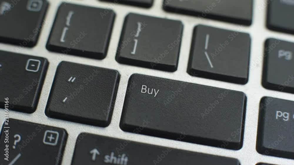 Buy button on computer keyboard, female hand fingers press key Buy button on computer keyboard, female hand fingers press key