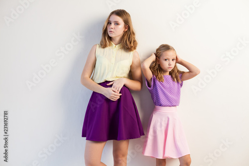 two fashionable girls sisters in beautiful clothes portrait