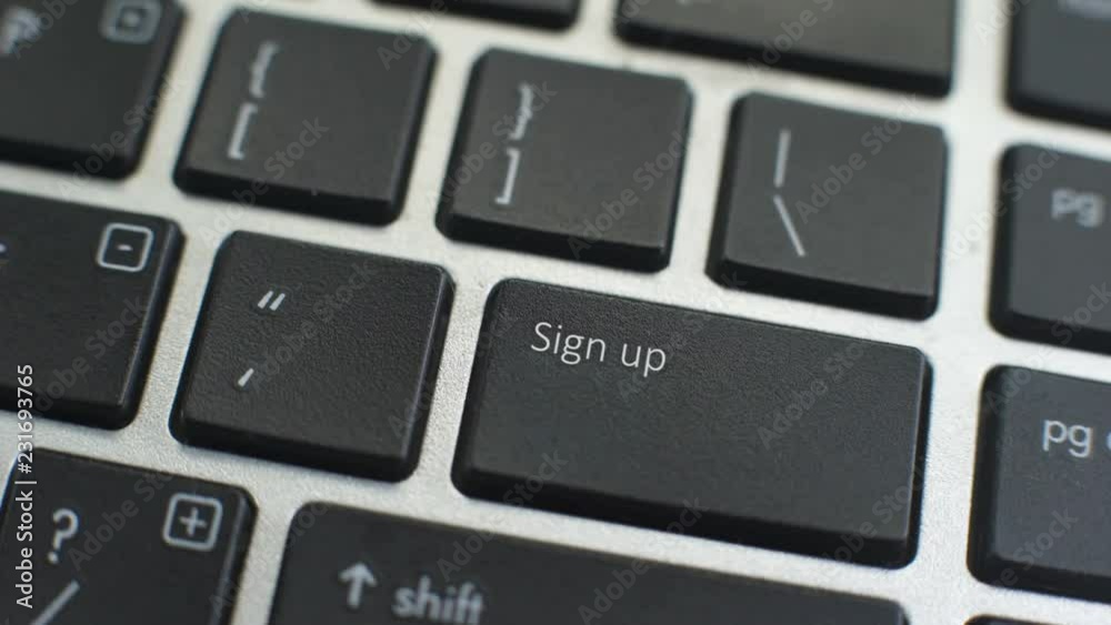 Sign up button on computer keyboard, female hand fingers press key Sign up button on computer keyboard, female hand fingers press key