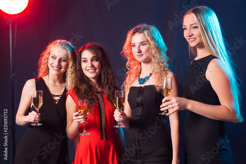 Party, new year and people concept - Cheerful young women clinking glasses of champagne at the party