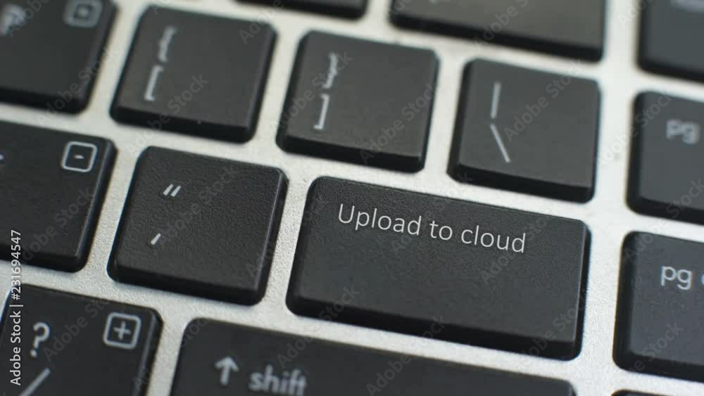 Upload to cloud button on computer keyboard, female hand fingers press key Upload to cloud button on computer keyboard, female hand fingers press key