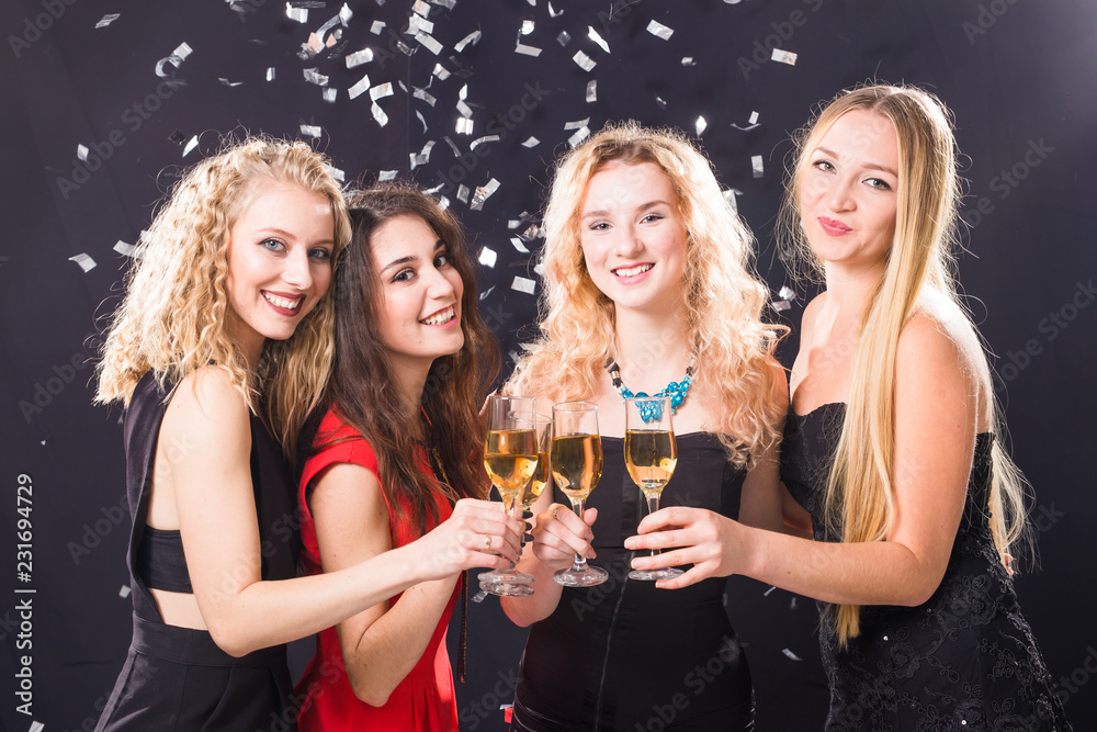 Party, new year and people concept - Cheerful young women clinking glasses of champagne at the party