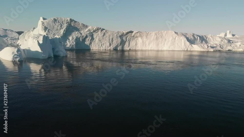 Wallpaper Mural 4k 60fps Greenland Aerial view at sunrise of humback whale blowing near huge iceberg of Sermeq Kujalleq glacier Ilulissat disko bay - large view Torontodigital.ca
