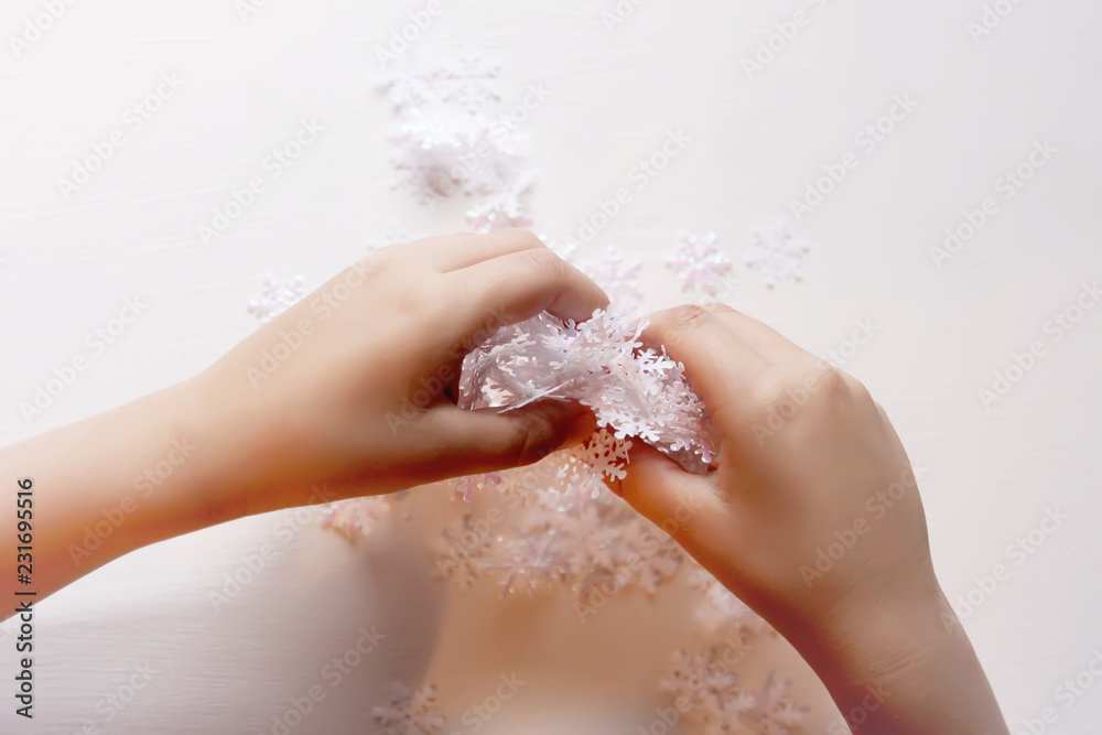 Child holds decorative paper snowflakes in hands. Child holds decorative paper snowflakes in hands.
