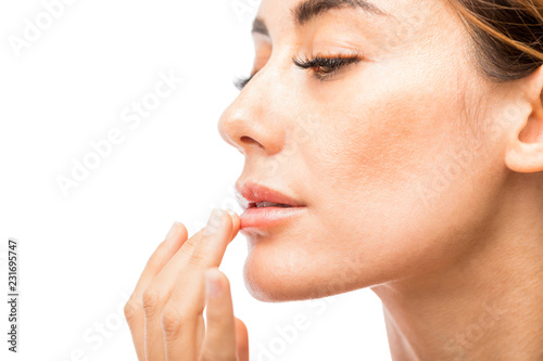 Woman Using Lip Balm In Studio