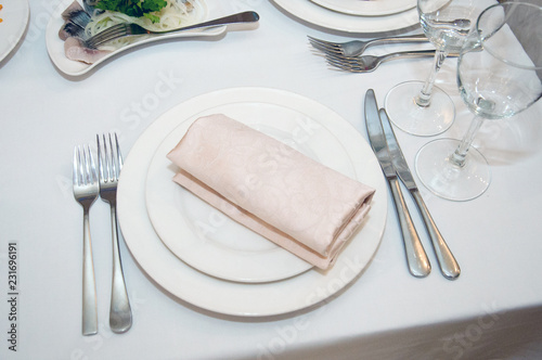 White plate  knife  fork  glass  napkin on a white background