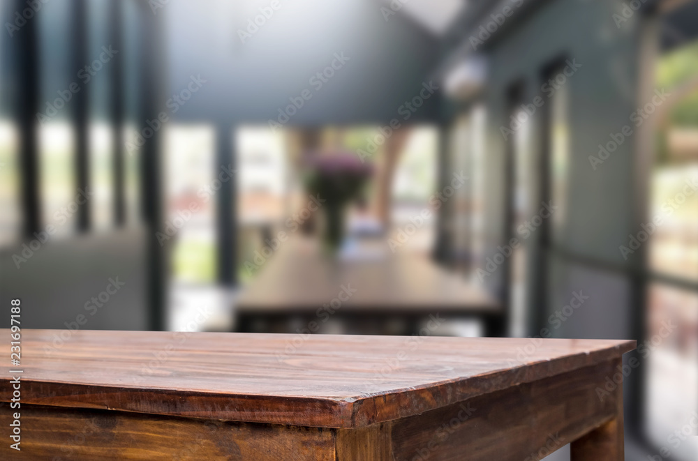 Selected focus empty brown wooden table and Coffee shop or restaurent blur background with bokeh image. for your photomontage or product display. Selected focus empty brown wooden table and Coffee shop or restaurent blur background with bokeh image. for your photomontage or product display.