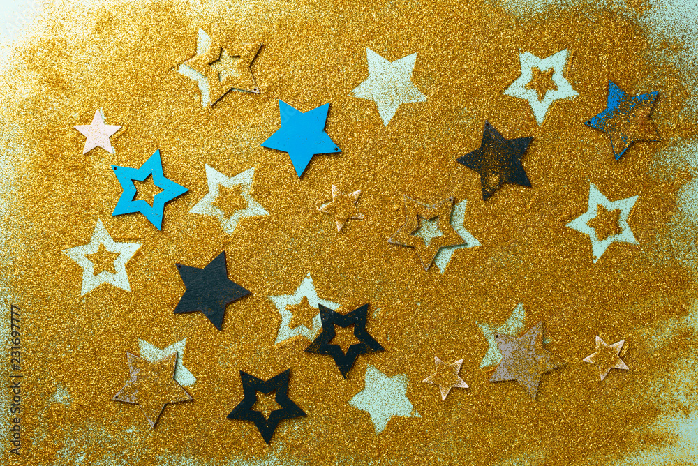 Christmas celebration. Abstract background for new year party. Patter of gold stars with lights, bokeh. Golden glitter stars on yellow shimmer texture Christmas celebration. Abstract background for new year party. Patter of gold stars with lights, bokeh. Golden glitter stars on yellow shimmer texture