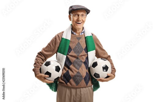 Senior soccer fan holding two soccer balls photo