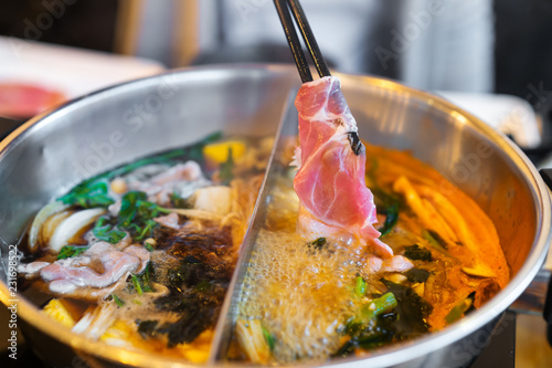 sliced pork meat in shabu or sukiyaki or Japanese hot pot photo