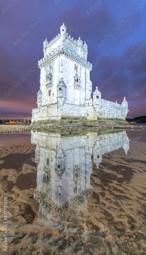 Belem Tower with water reflections at night, Lisbon - Portugal