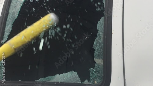 With audio vandalism of car window with baseball bat shattering glass into air with repetitive hits. 