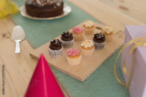 Cupcakes arranged on chopping broad