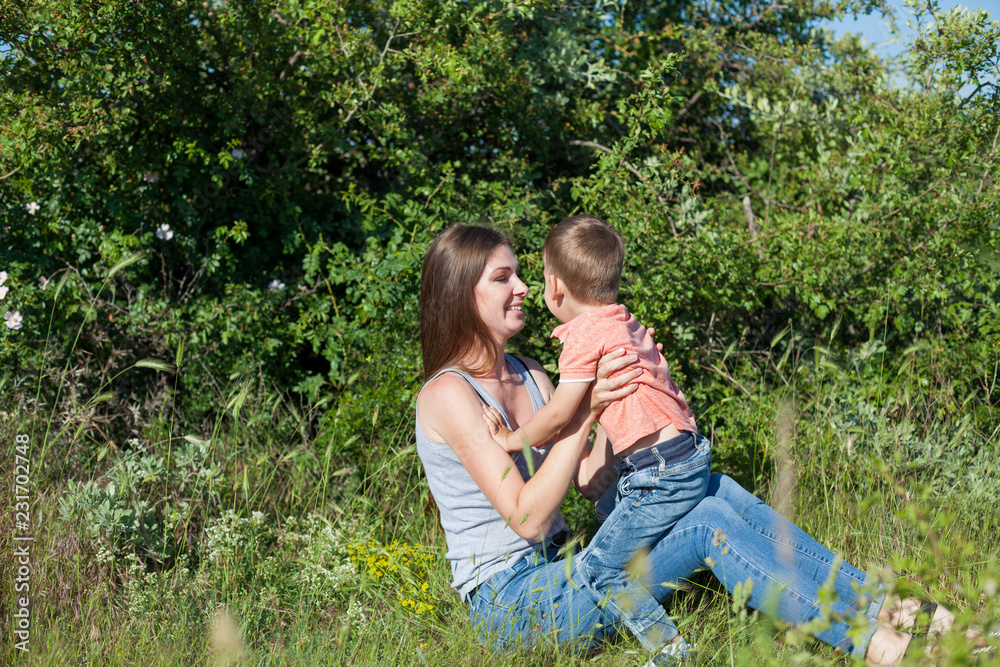 Fototapeta premium mom and young boy son play park love