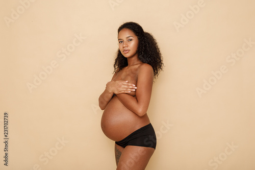 Portrait of a pregnant woman, looking at camera